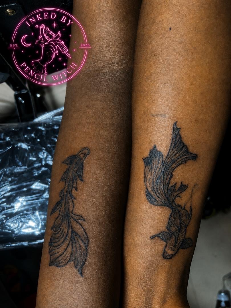 Matching koi tattoos on two forearms