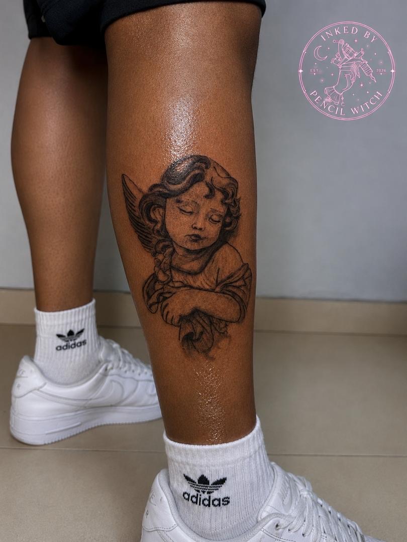 Sleeping cherub tattoo on the calf with fine linework