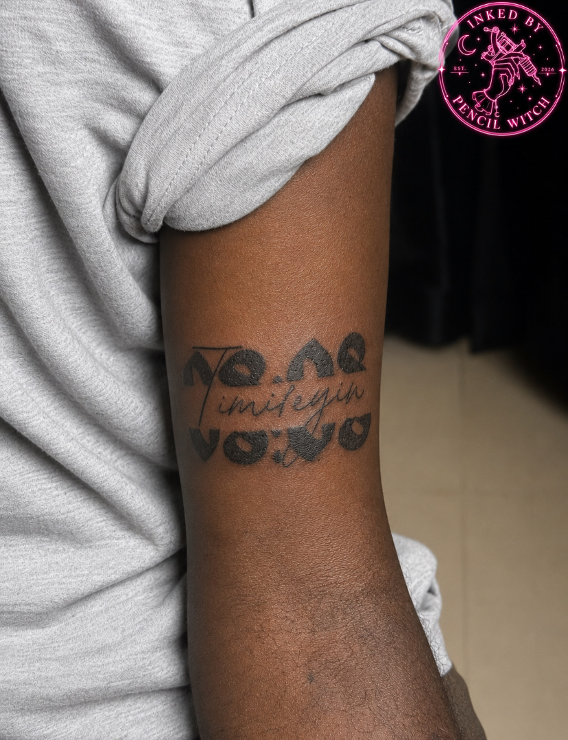 Bold tattoo reading 08:08 with the name Timileyin scripted through the center — the time and name of the wearer's newborn daughter