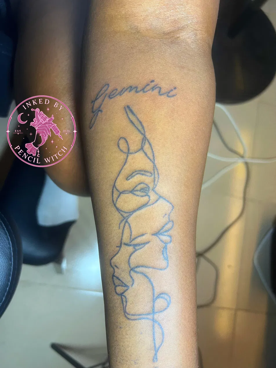 Single-line drawing of two entwined faces with the word 'gemini' scripted above, on the forearm
